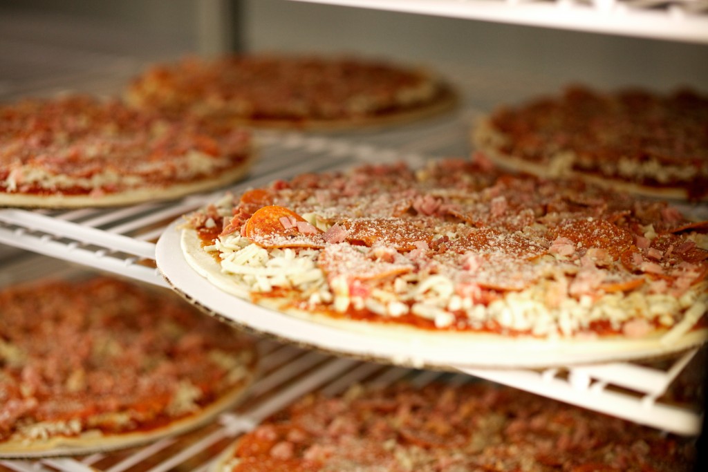 pizzas sitting in the freezer.