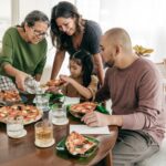 This Is A Photo Of A Family Eating Pizza For Dinner.