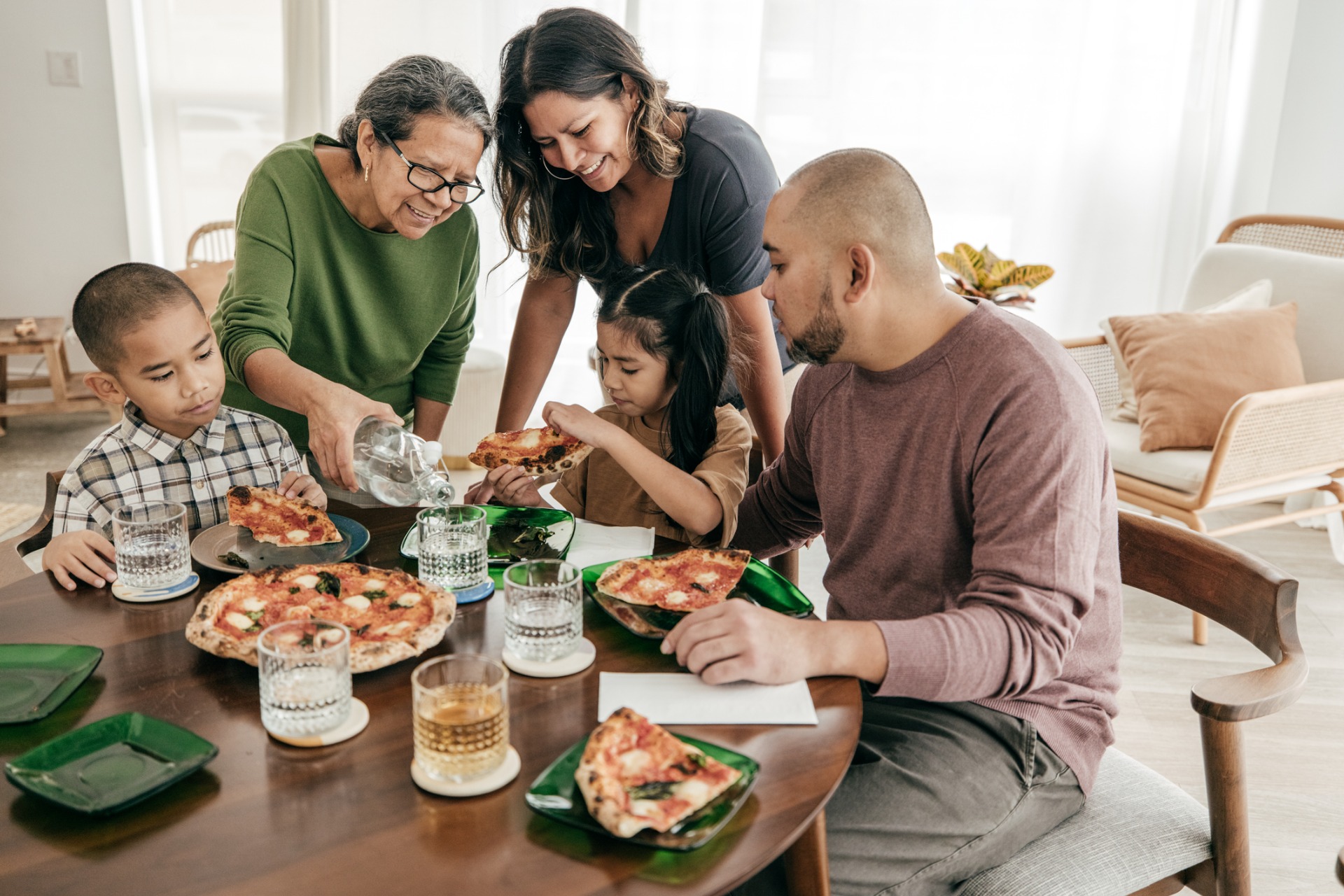 This is a photo of a family eating pizza for dinner.
